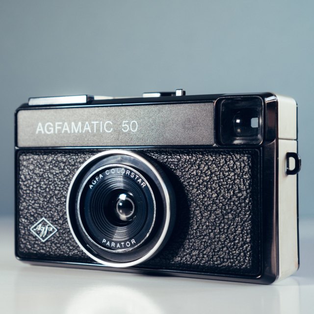 eBay listing photo made with this tool: a 1600×1600 JPEG of an Agfa Agfamatic 50 camera, front on, on a pale grey-blue background