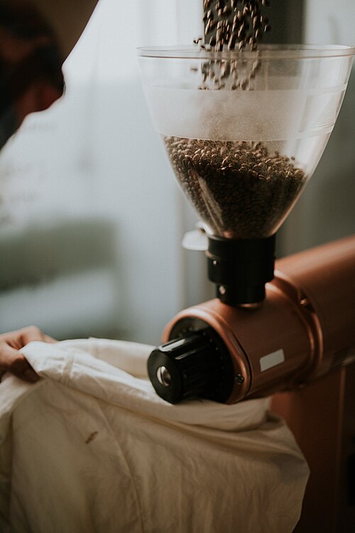 Coffee being ground by hand (CC0, Nathan Dumlao)