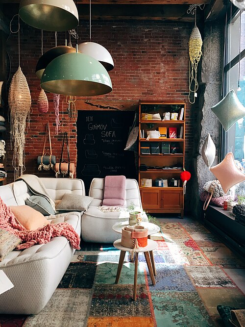 A furnished living room with a grey sofa (CC0, Stephen Di Donato)